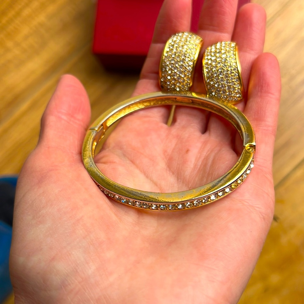 Signed Christian Dior bracelet and earrings gold tone set with crystals.